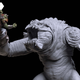 Hasbro's Black Series Haslab Rancor action figure, rendered in unfinished greyscale, lifts a colored Gamorrean Guard action figure to its mouth.